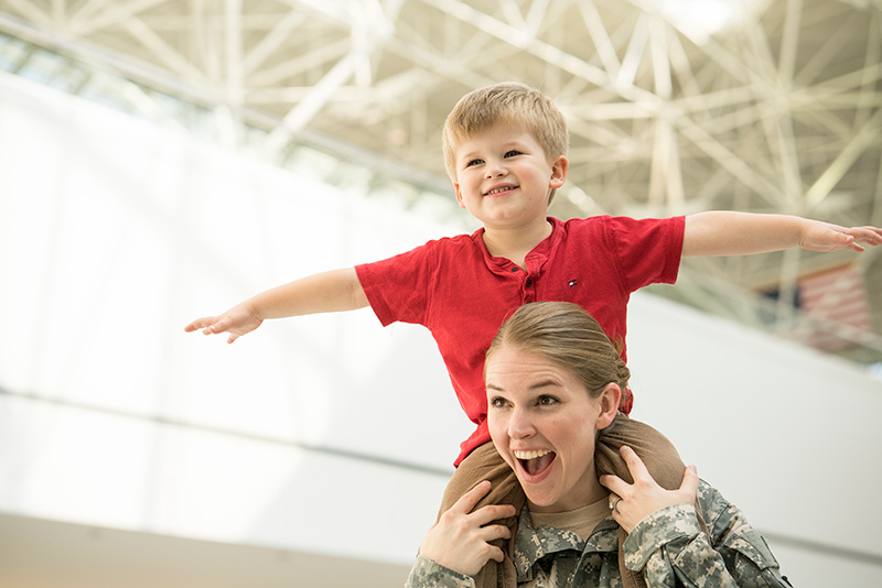 serviceperson and son in BWI Marshall Airport