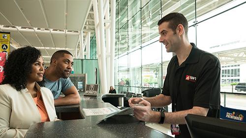 Couple getting help at a BWI information desk