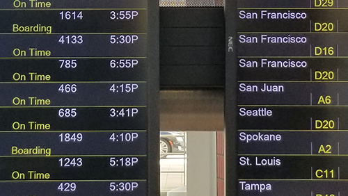 Flight boards show arrivals and departures at BWI Marshall Airport. 
